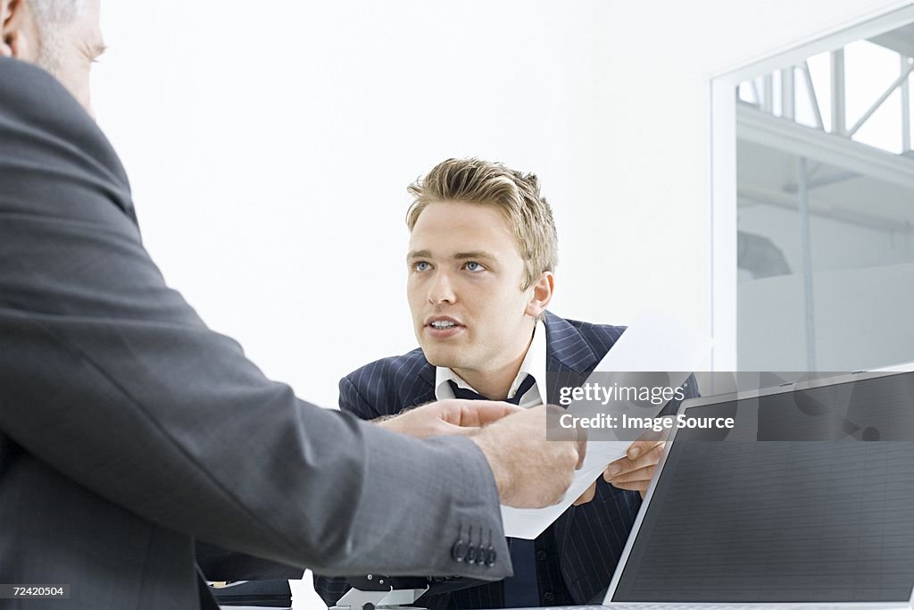 Businessmen with a piece of paper