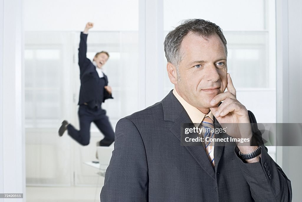 Businessmen thinking and jumping