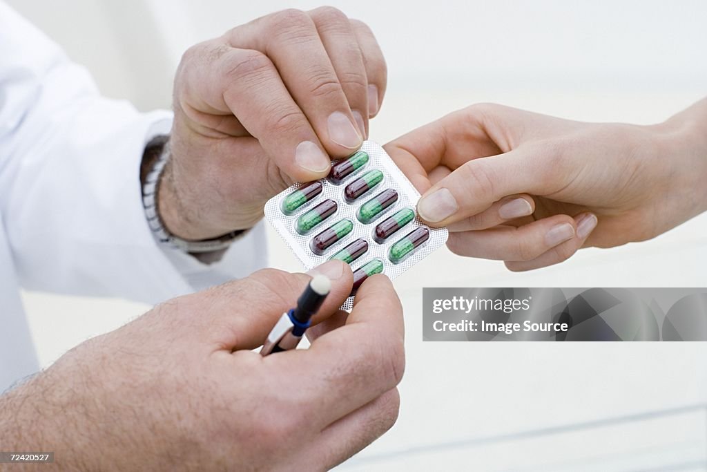 Doctor handing over tablets