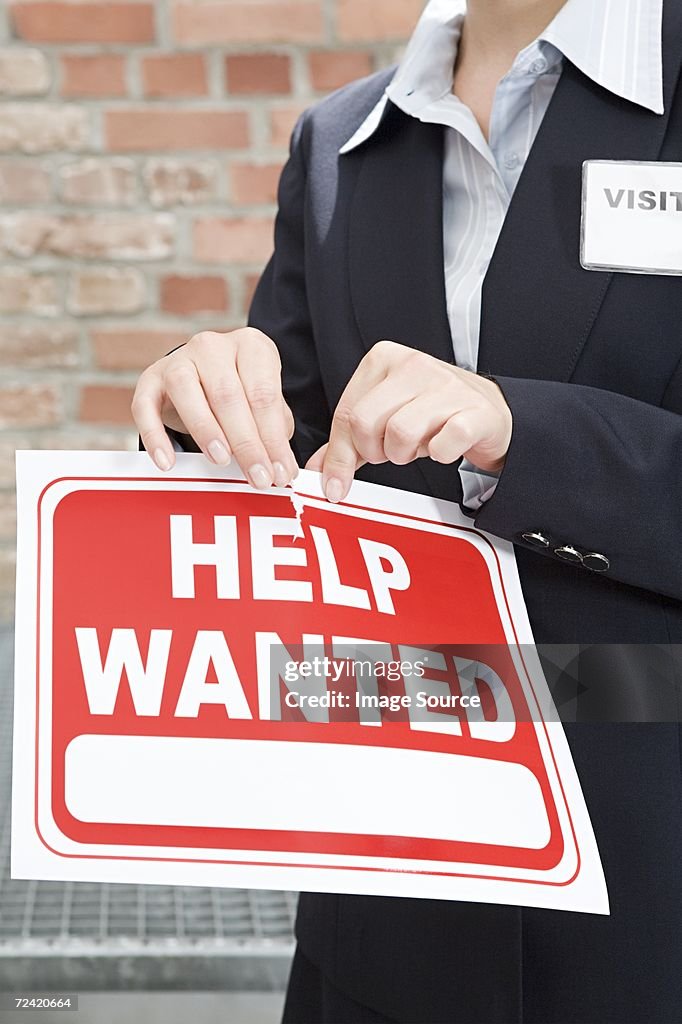 Woman tearing sign