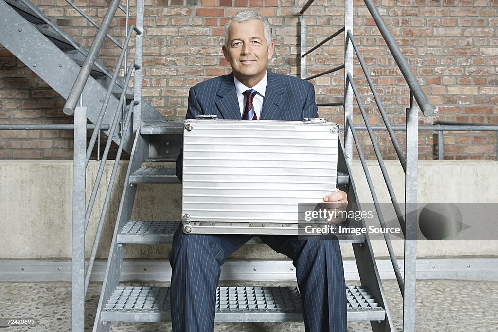 Businessman on steps with briefcase