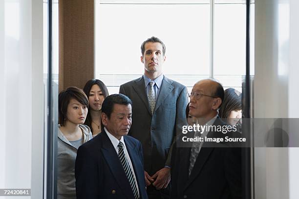 people in an elevator - tall stock pictures, royalty-free photos & images