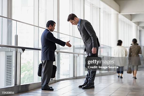 businessmen greeting - david cameron greets the prime minister of japan stockfoto's en -beelden