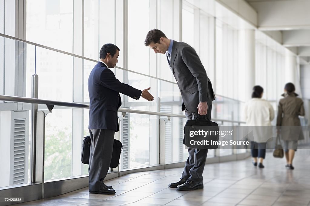 Businessmen greeting
