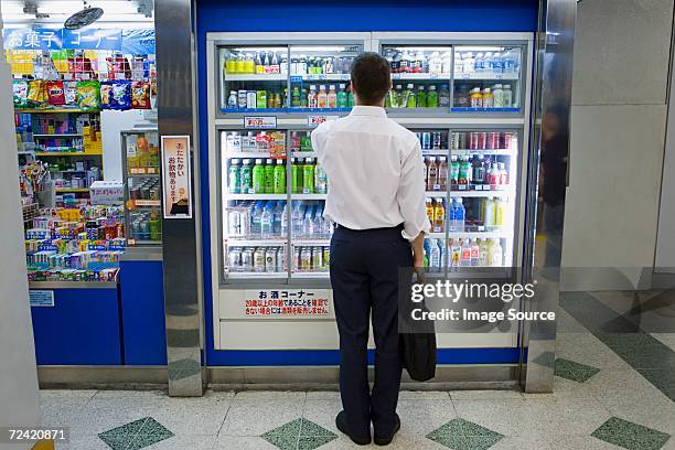 businessman choosing - beverage fridge stock pictures, royalty-free photos & images