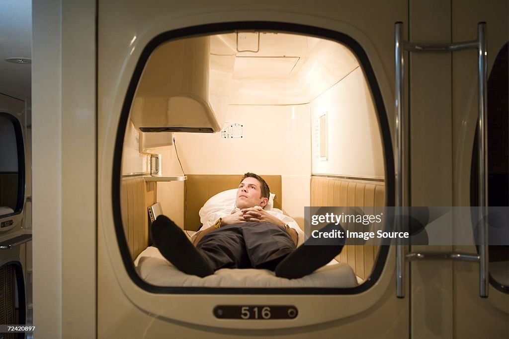 Businessman in a capsule hotel