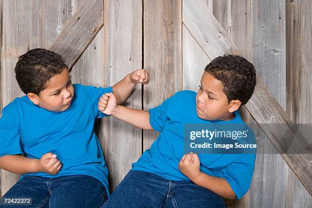 twin boys fighting - twin boys stock pictures, royalty-free photos & images