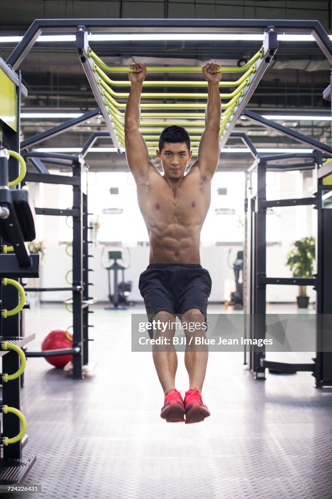 Young man exercising at gym