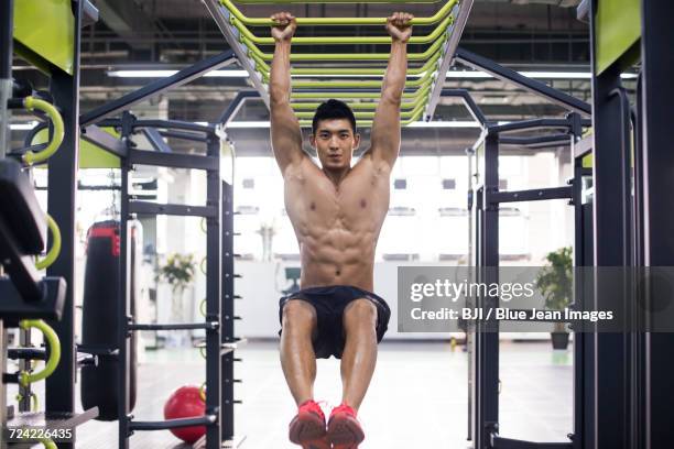 young man exercising at gym - pectoral muscle stock pictures, royalty-free photos & images