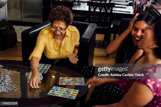 mother, grandmother and girl playing game - game night leisure activity fotografías e imágenes de stock