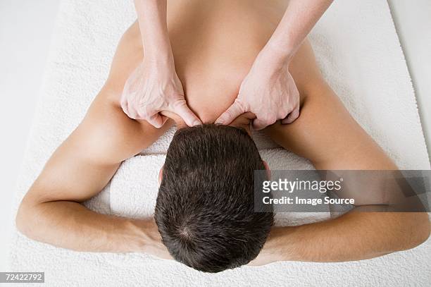 man being massaged - massage table white background stock pictures, royalty-free photos & images