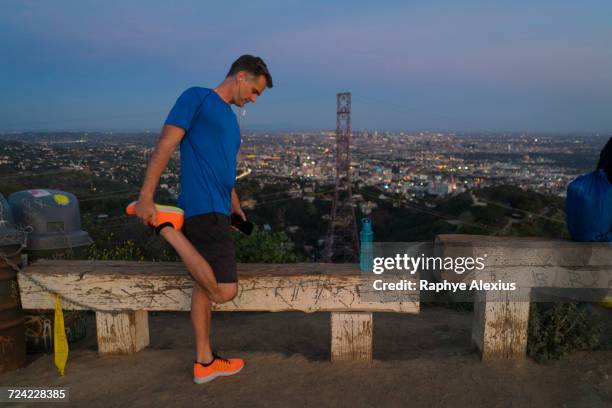 jogger stretching leg, runyon canyon, los angeles, california, usa - runyon canyon stock pictures, royalty-free photos & images