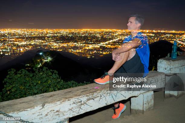 long exposure of jogger on bench looking away at view, runyon canyon, los angeles, california, usa - runyon canyon stock pictures, royalty-free photos & images