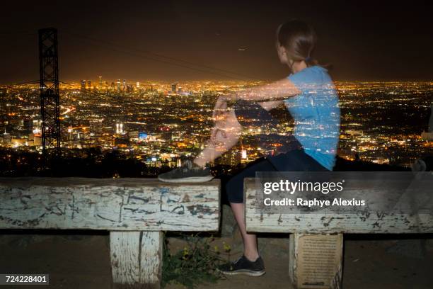 long exposure of jogger on bench looking away at view, runyon canyon, los angeles, california, usa - runyon canyon stock pictures, royalty-free photos & images