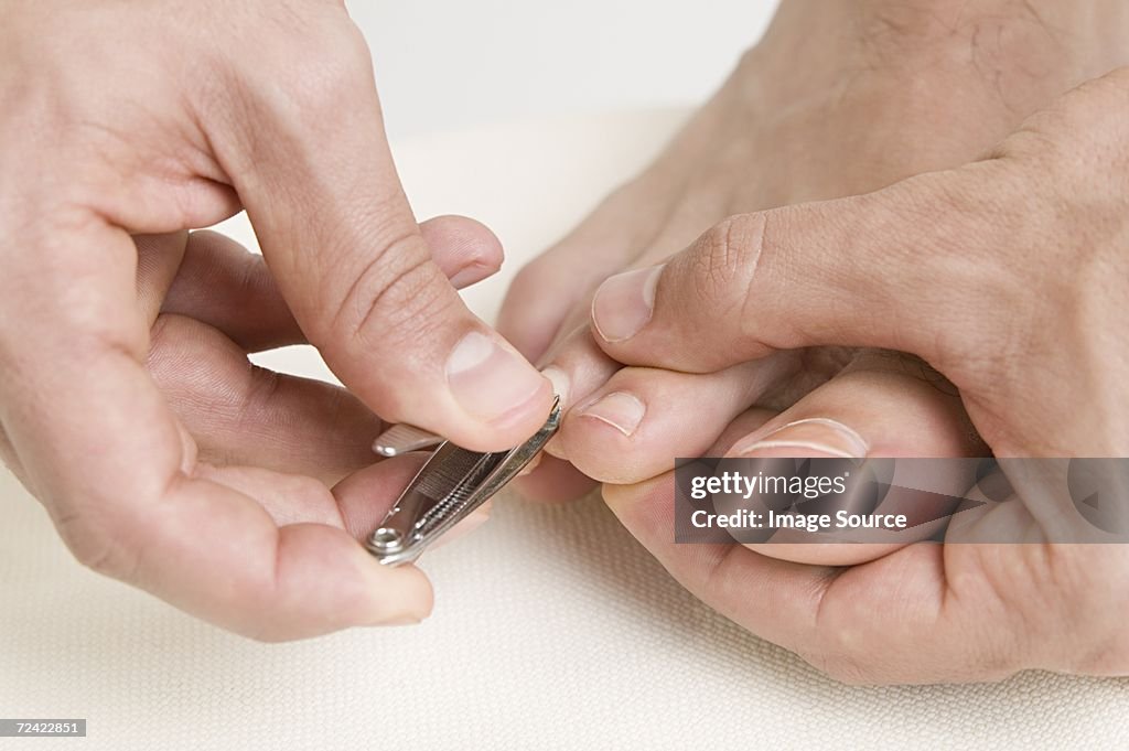 Man clipping his toe nails