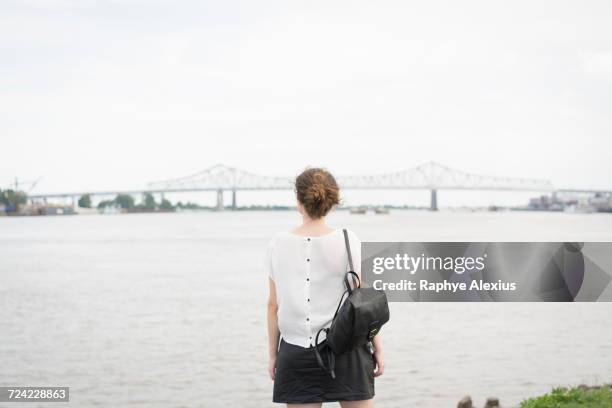 rear view of woman looking at new orleans bridge, mississippi river, french quarter, new orleans, louisiana, usa - new orleans bridge stock pictures, royalty-free photos & images