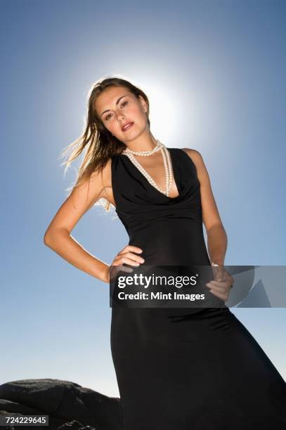 portrait of young blond woman in back evening gown. - abendgarderobe stock-fotos und bilder