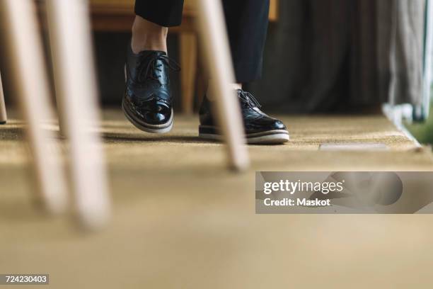 low section of businessman wearing formal shoes in portable office truck - formal office stock pictures, royalty-free photos & images