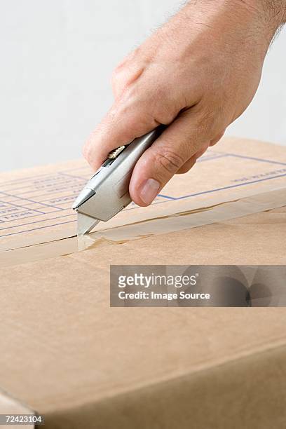 man opening box - craft knife stock pictures, royalty-free photos & images
