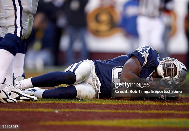 Wide Receiver Terrell Owens of the Dallas Cowboys takes a nap using the ball as a pillow after scoring a touchdown in the third quarter against the...