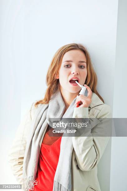 woman using spray in mouth - mouth spray stock pictures, royalty-free photos & images