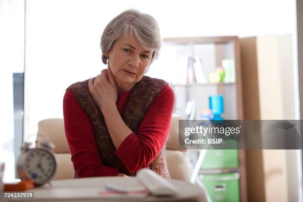 cervicalgia in an elderly person - human neck stock pictures, royalty-free photos & images