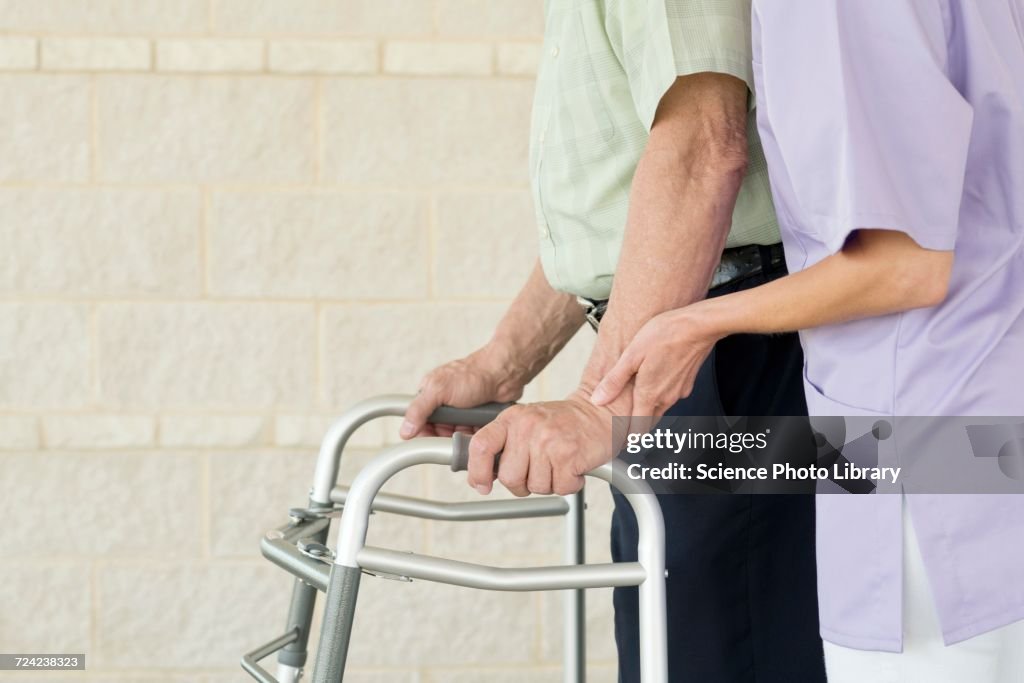 Senior man using walking support frame
