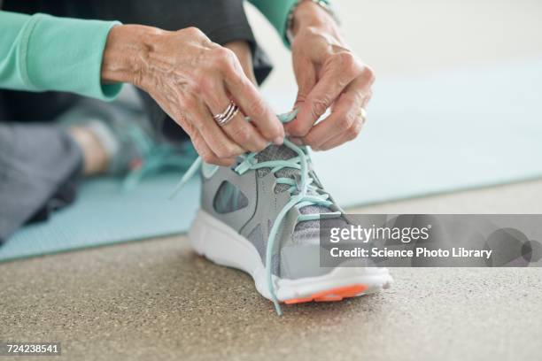 senior woman lacing up trainers - tied up stock pictures, royalty-free photos & images