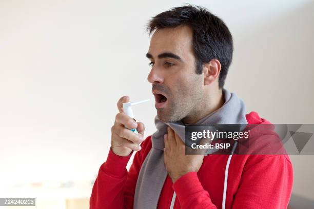 man using mouth spray - mouth spray stock pictures, royalty-free photos & images