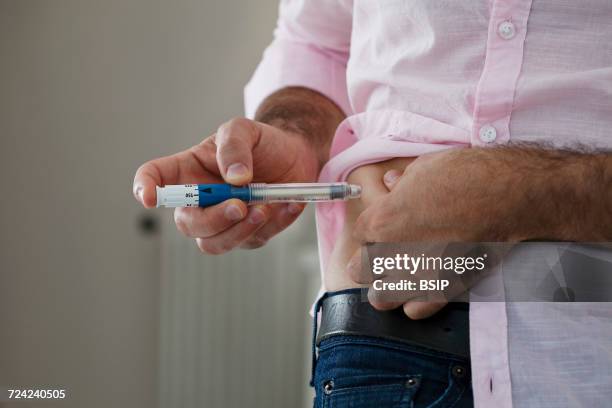 Diabetic Injecting A Diabetic Injecting Himself With Insulin Photos and Premium High Res ...