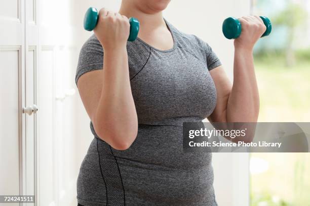 woman using hand weights - hand weight stock pictures, royalty-free photos & images