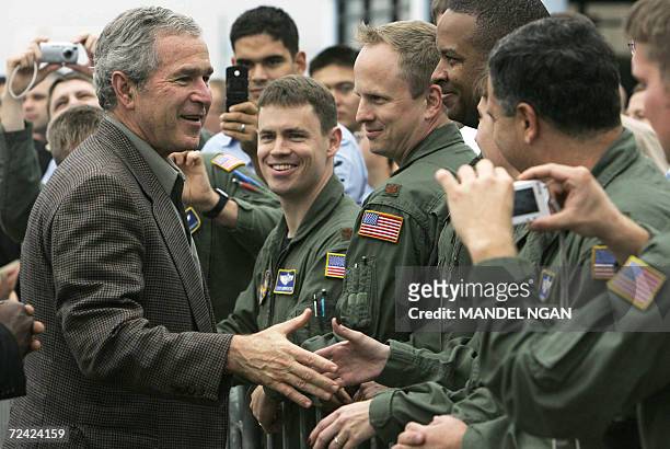 Pensacola, UNITED STATES: US President George W. Bush greets servicemen at Naval Air Station Pensacola before boarding Air Force One 06 November 2006...