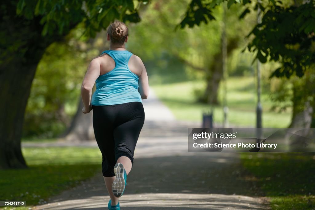 Young woman running on path, rear view