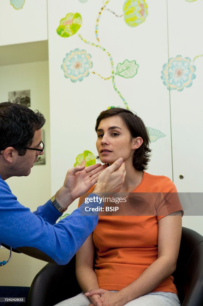 Woman palpating lymph node