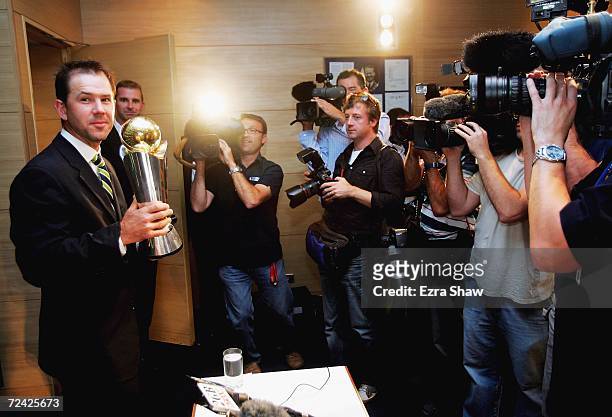 Ricky Ponting of Australia is surrounded by media as he holds the ICC Champions Trophy following a press conference after the victorious Australian...