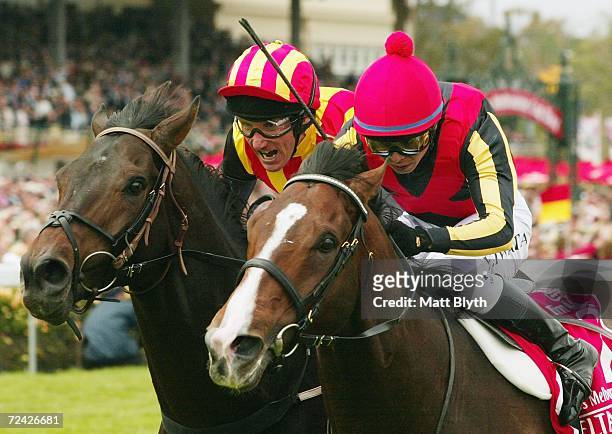 Yasunari Iwata riding Delta Blues leads Damien Oliver riding Pop Rock during the Emirates Melbourne Cup during The Melbourne Cup Carnival meeting at...
