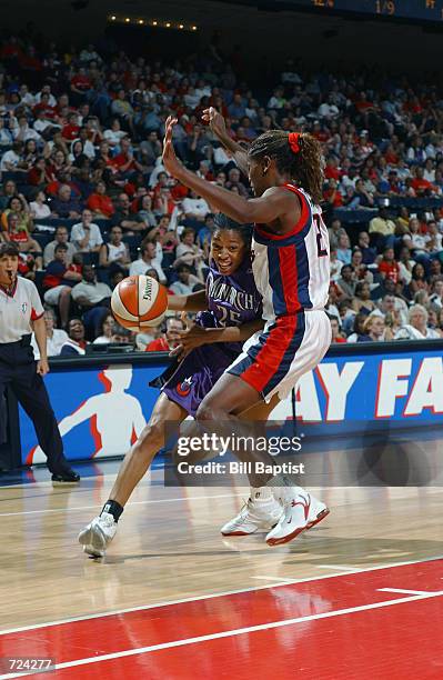 Kedra Holland-Corn of the Sacramento Monarchs drives around Sheryl Swoopes of the Houston Comets during the game at Compaq Center in Houston, Texas...