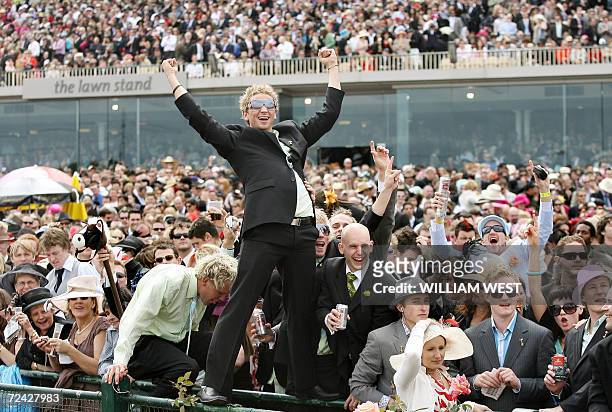 Fans celebrate in the huge crowd as Japanese horse Delta Blues wins the five million Australan dollar Melbourne Cup horse race, 07 November 2006....