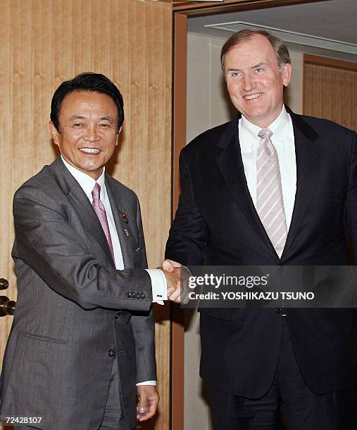 Visiting US Deputy Secretary of Treasury Robert Kimmit shakes hands with Japanese Foreign Minister Taro Aso prior to their talks at Aso's office in...