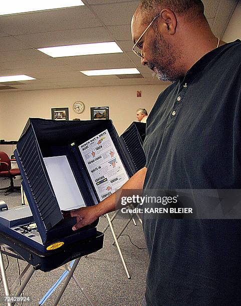 Election official Ralph Wheeler sets up an electronic voting machine 07 November, 2006 before the opening to voters at the Sudley North Government...