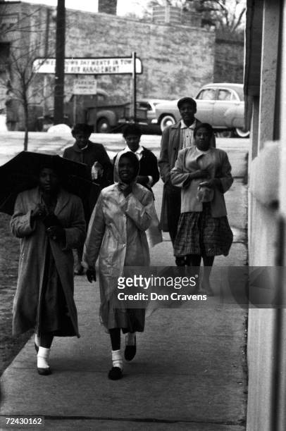 African American citizens walking to work and/or shopping during the civil rights bus boycott in Montgomery.