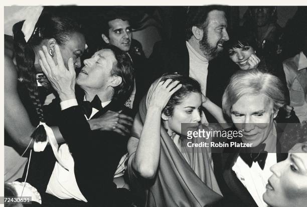 Celebrities during New Year's Eve party at Studio 54: Halston [kissing unidentified], Bianca Jagger, Jack Haley Jr. And wife Liza Minnelli, Andy...