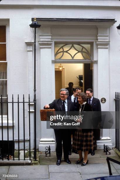 Sir Geoffrey Howe leaves his house on Downing St. Followed by his wife & 2 male Secretarys. En route to the House of Commons, carrying the "budget...