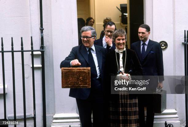 Sir Geoffrey Howe leaves his house on Downing St. Followed by his wife & 2 male Secretarys. En route to the House of Commons, carrying the "budget...
