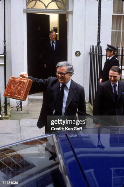 Sir Geoffrey Howe leaves his house on Downing St. Followed by his wife & 2 male Secretarys. En route to the House of Commons, carrying the "budget...