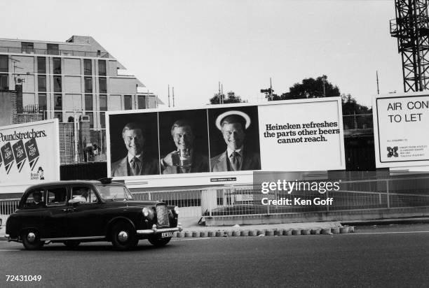 Taxi driving by billboard featuring Larry Hagman in a Heineken ad.