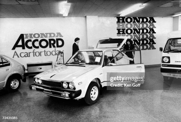 British auto shoppers looking over Japanese import at "Power Car-Slough" Honda dealer on the southwest outskirts of London.