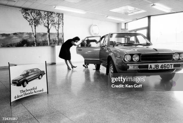 British auto shoppers looking over Japanese import at "Power Car-Slough" Honda dealer on the southwest outskirts of London.