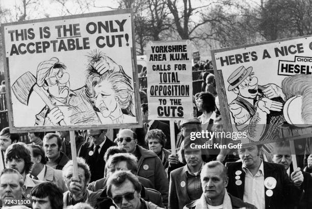 Demonstrators marching in London to protest the Tory governments spending cuts.