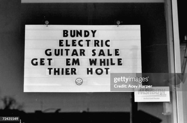 Sign at music instrument store announcing sale on electric guitars re. Recent execution of serial killer Ted Bundy.